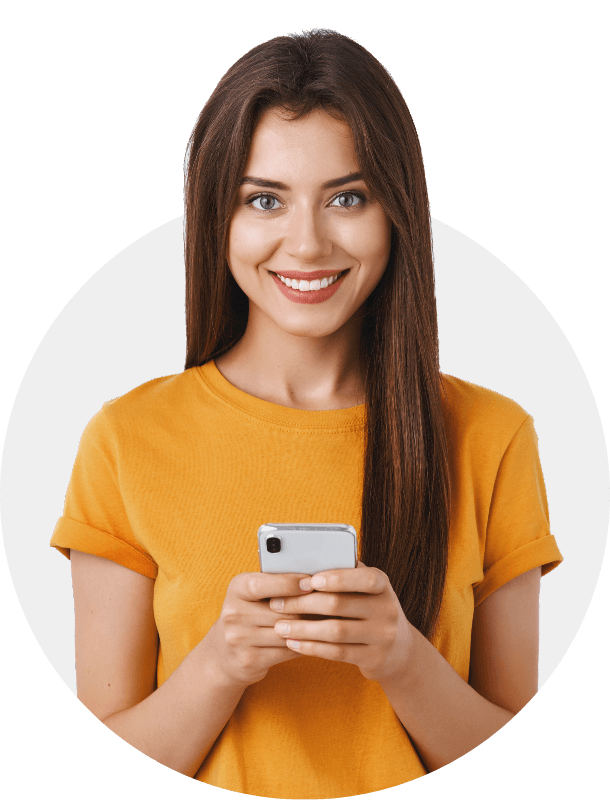 Smiling young woman holding a smartphone